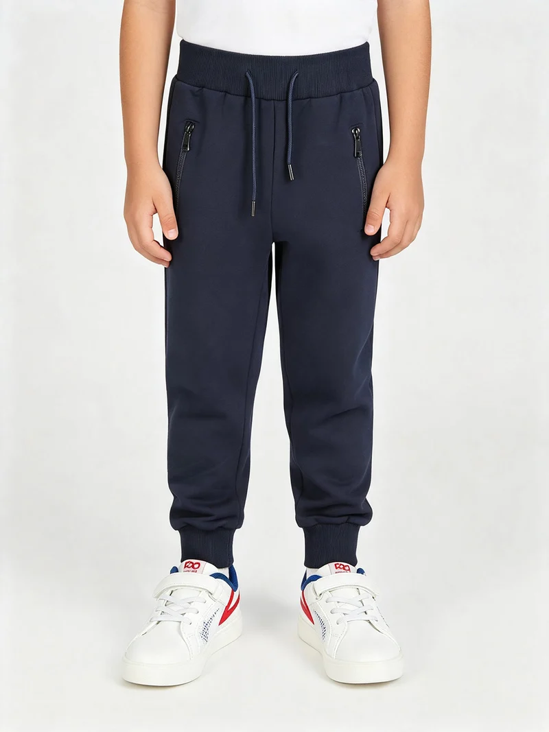 Pantaloni tuta da bambino con polsini e coulisse - blu scuro