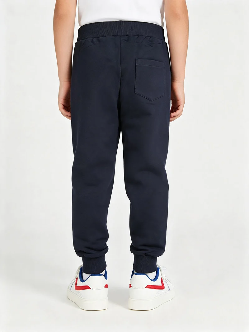 Pantaloni tuta da bambino con polsini e coulisse - blu scuro