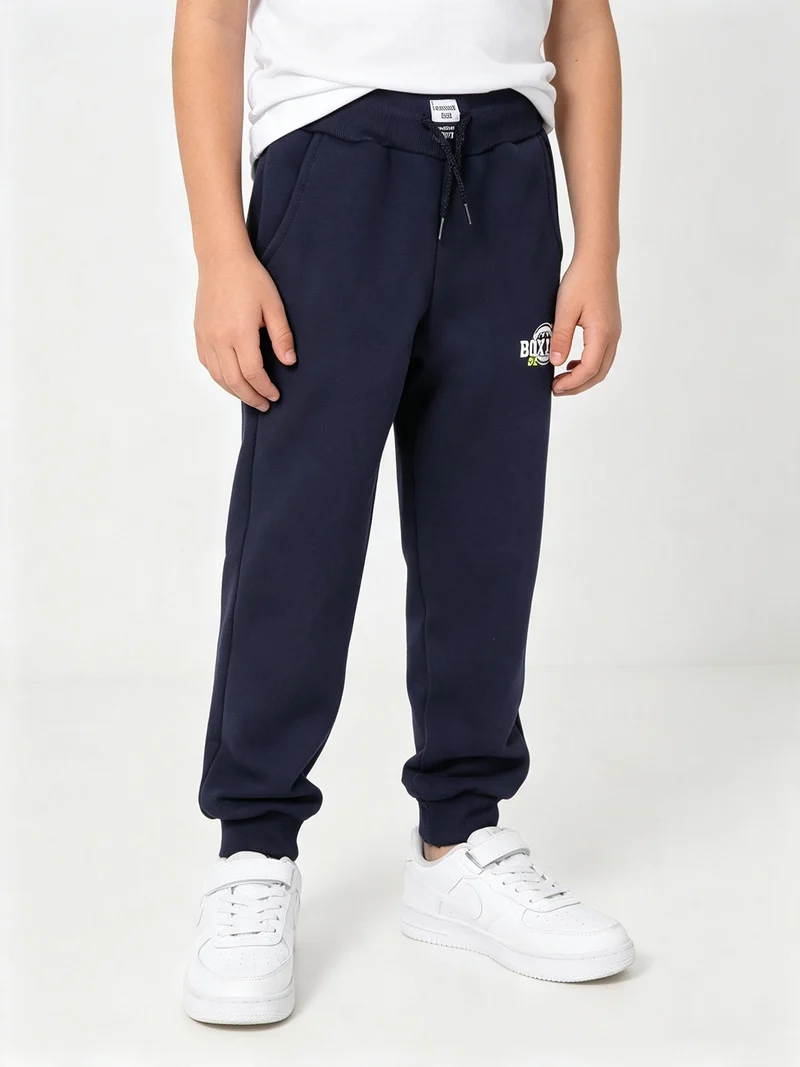 Pantaloni tuta da ragazzo in felpa con coulisse e polsini - blu scuro