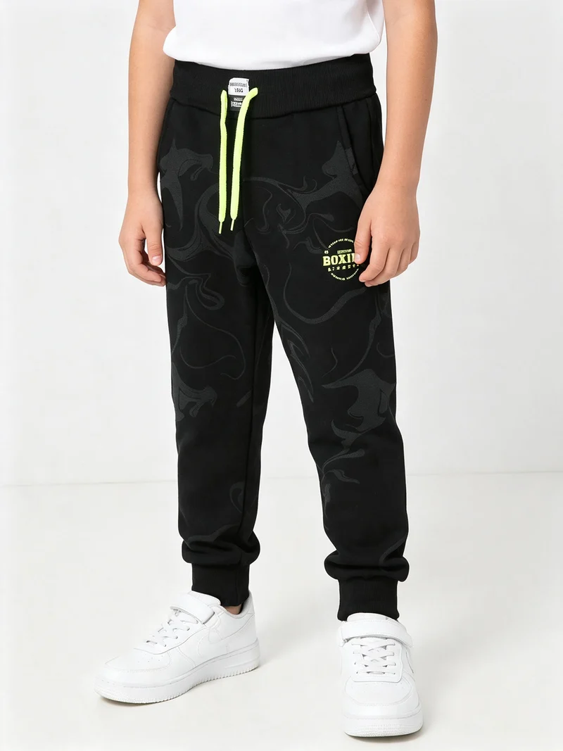 Pantaloni tuta da ragazzo in felpa con coulisse e polsini - nero