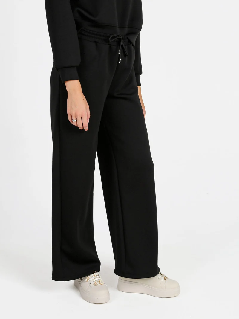 Pantaloni donna in felpa a gamba larga con coulisse - nero