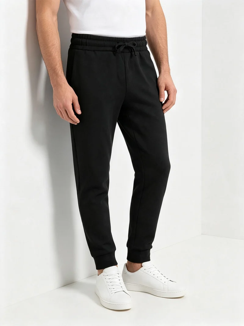 Pantaloni tuta da uomo con coulisse e polsini e interno felpato - nero