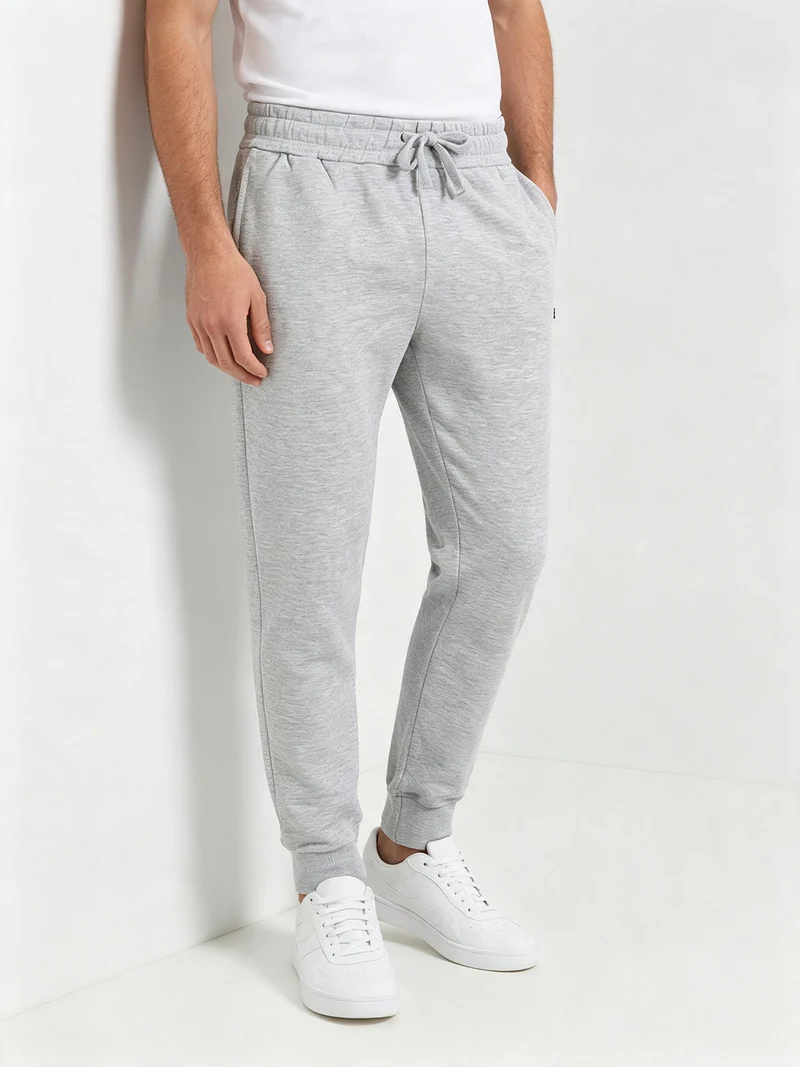 Pantaloni tuta da uomo con coulisse e polsini e interno felpato - grigio