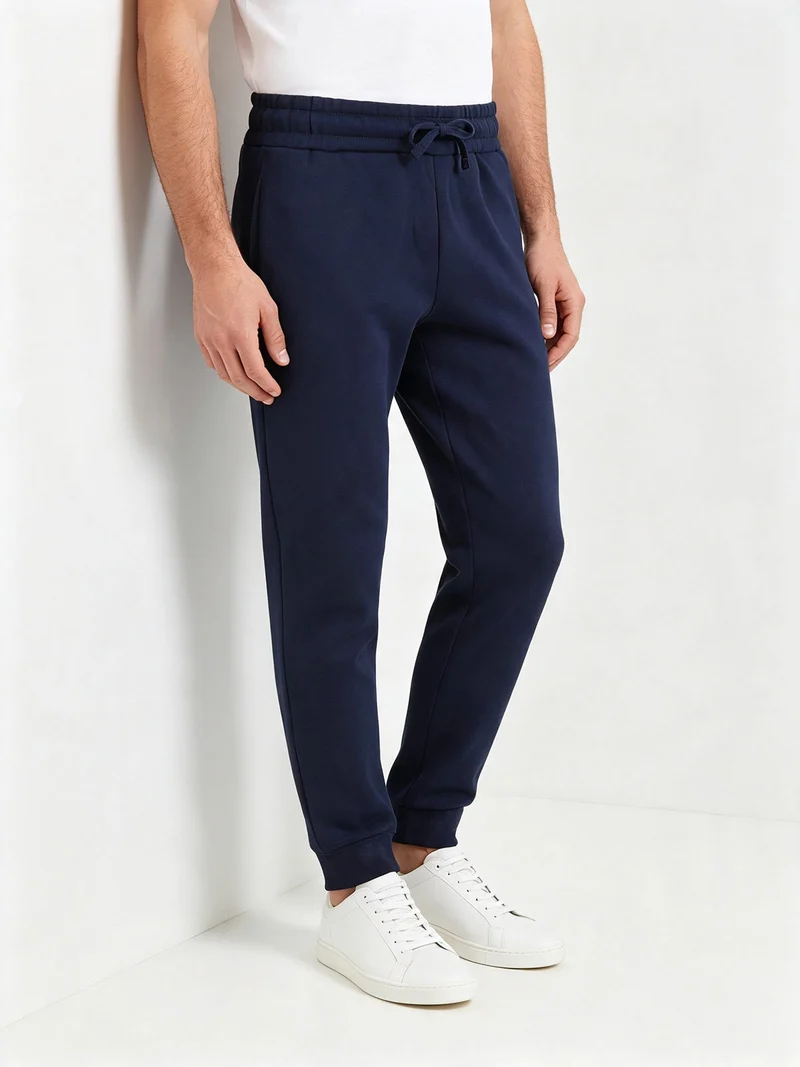 Pantaloni tuta da uomo con coulisse e polsini e interno felpato - blu scuro