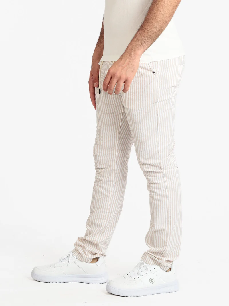 Pantaloni rigati in cotone con coulisse da uomo - beige