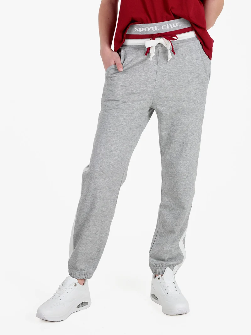 Pantaloni tuta da donna con coulisse e polsini - grigio