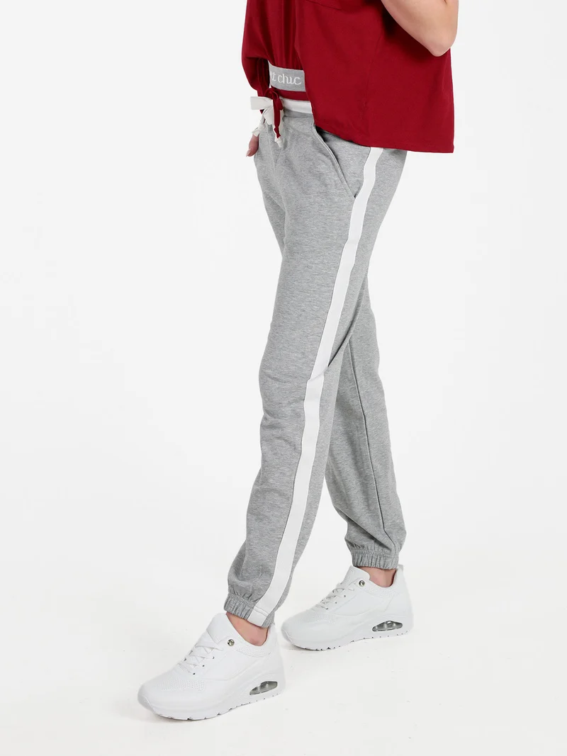 Pantaloni tuta da donna con coulisse e polsini - grigio