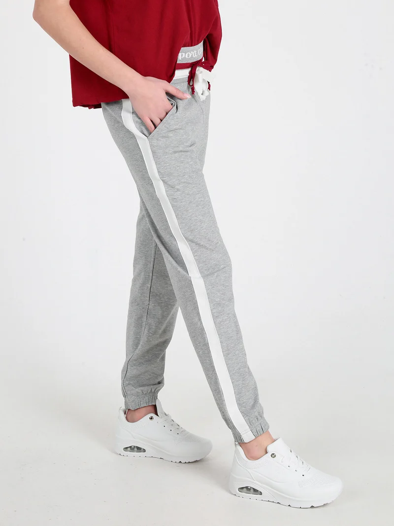 Pantaloni tuta da donna con coulisse e polsini - grigio