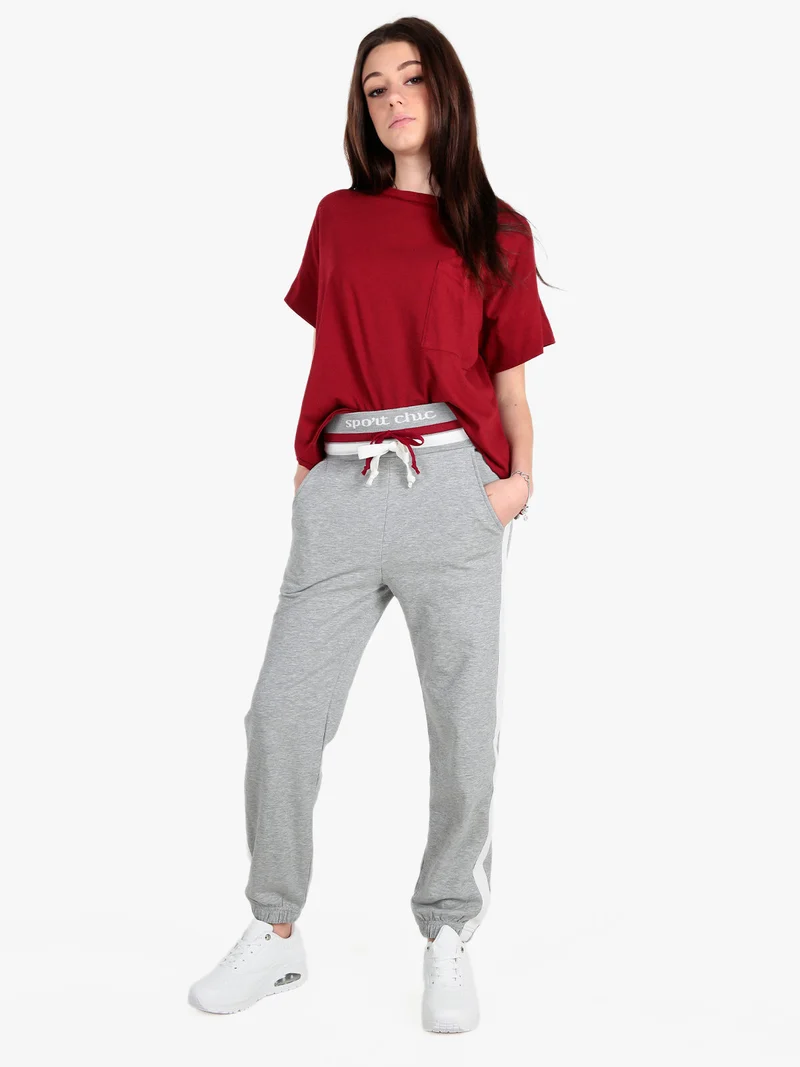 Pantaloni tuta da donna con coulisse e polsini - grigio