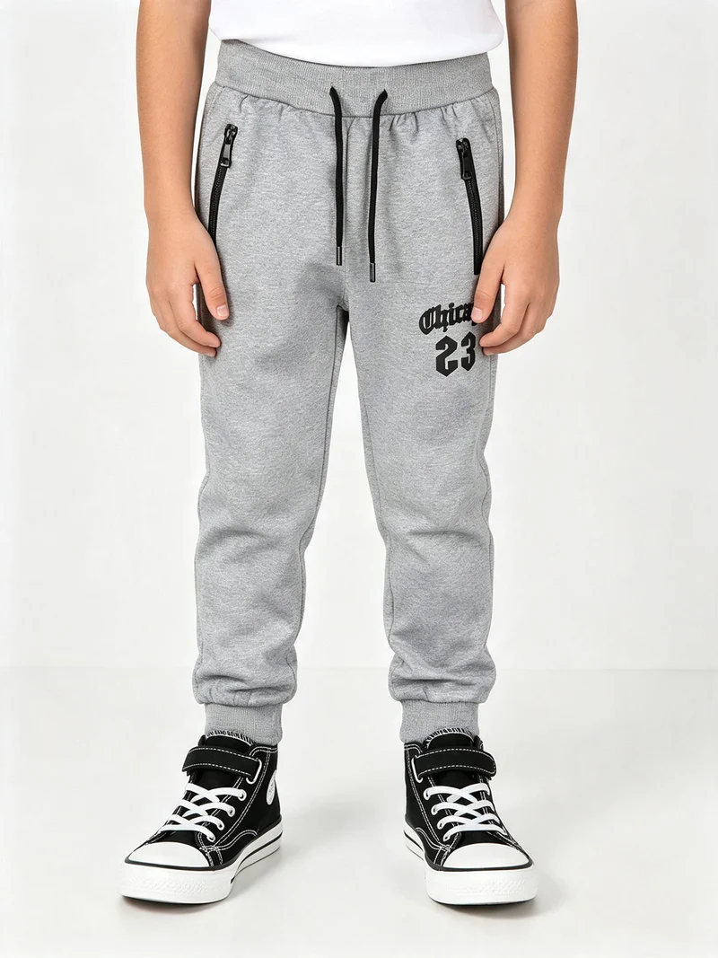 Pantaloni tuta da bambino con coulisse e polsini - grigio