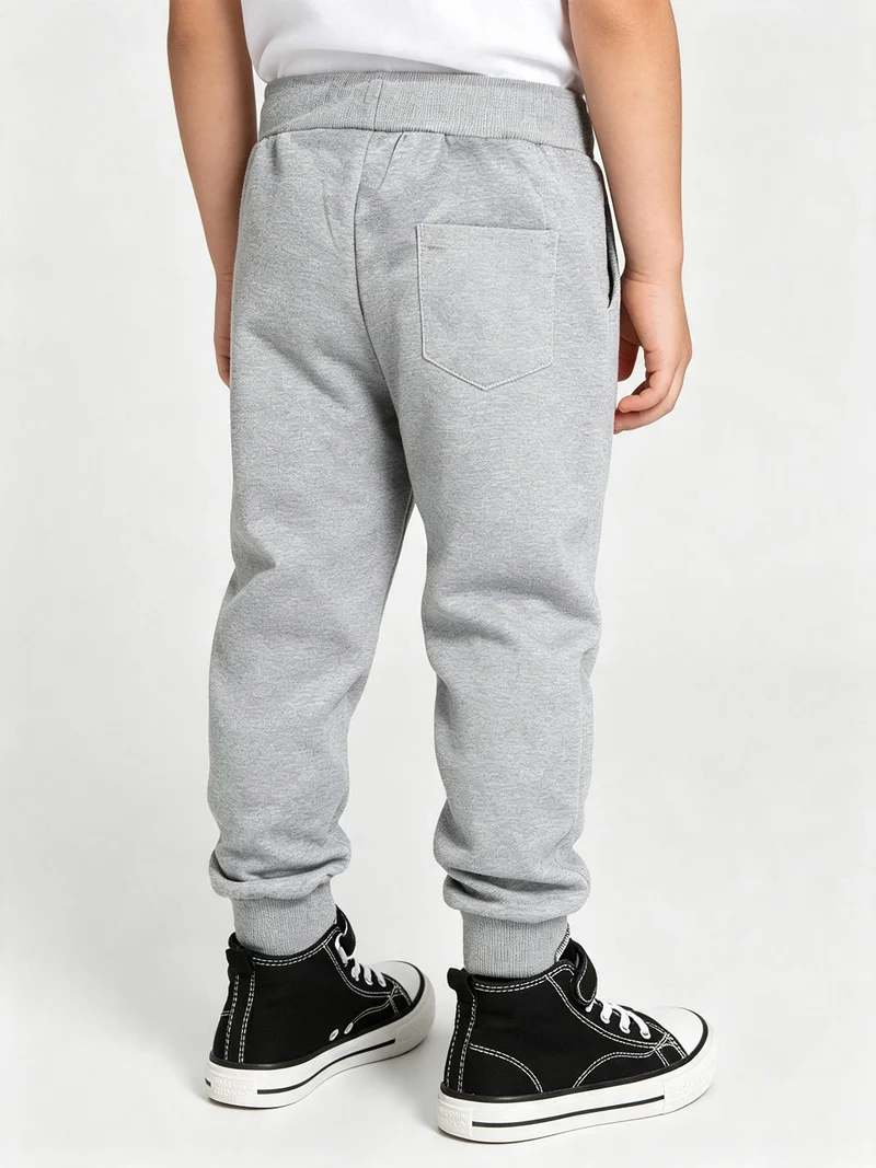 Pantaloni tuta da bambino con coulisse e polsini - grigio