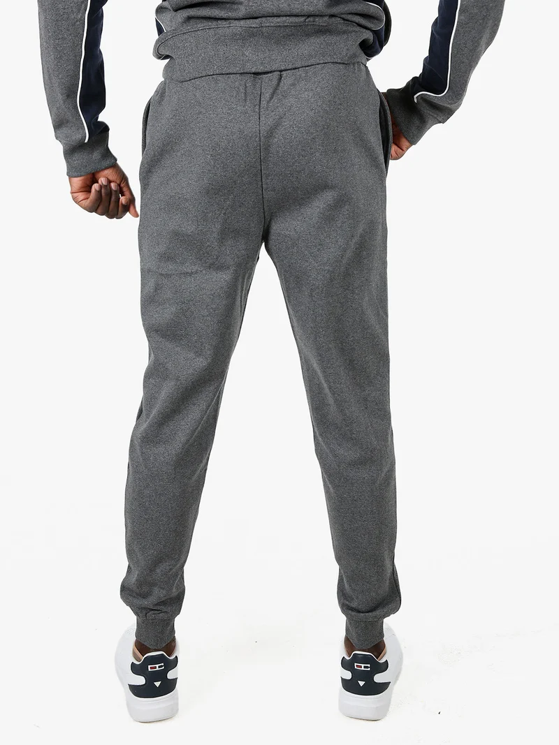 Pantaloni tuta da uomo con coulisse e polsini - grigio