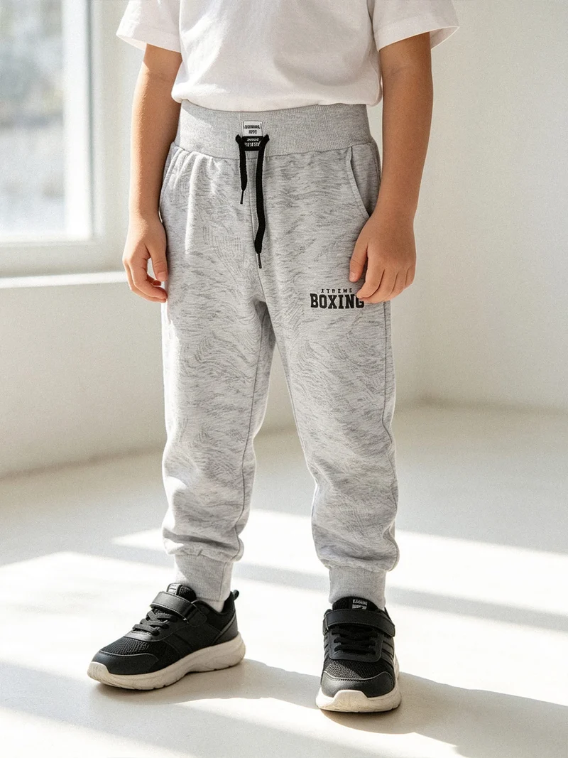 Pantaloni sportivi da ragazzo con coulisse e polsini - grigio