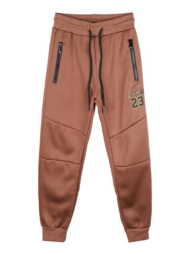 Pantaloni tuta da bambino con polsini - marrone