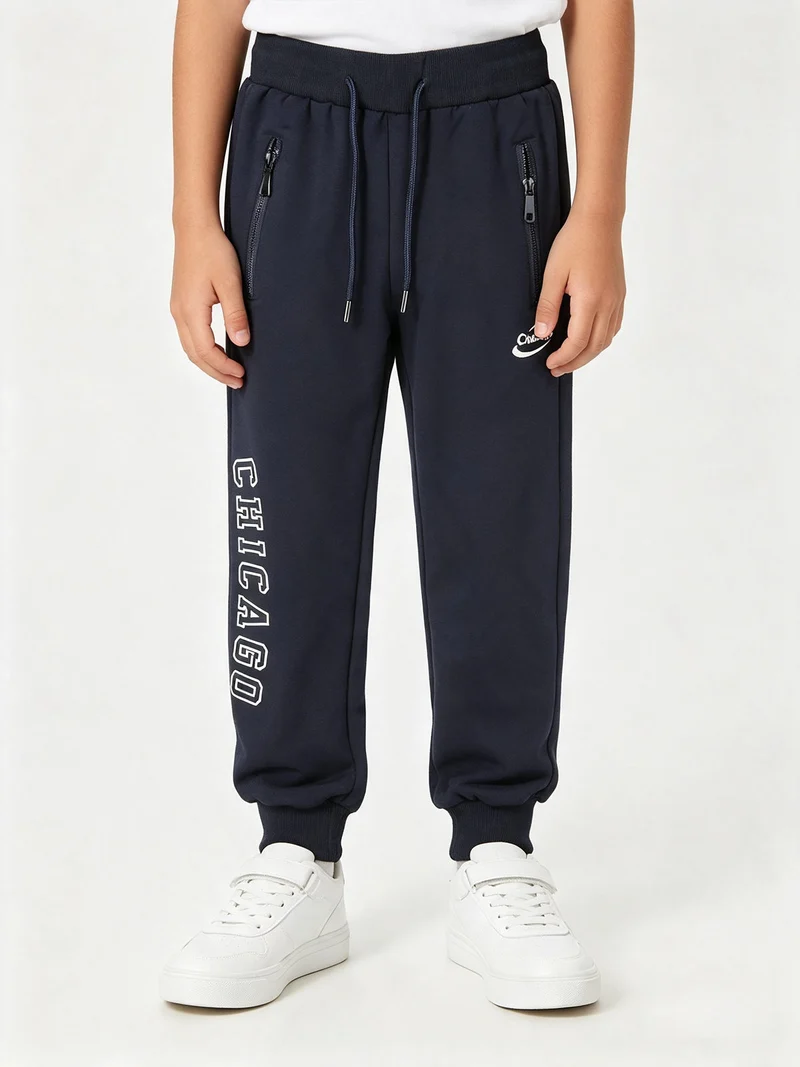 Pantaloni tuta da bambino con polsini e coulisse - blu scuro