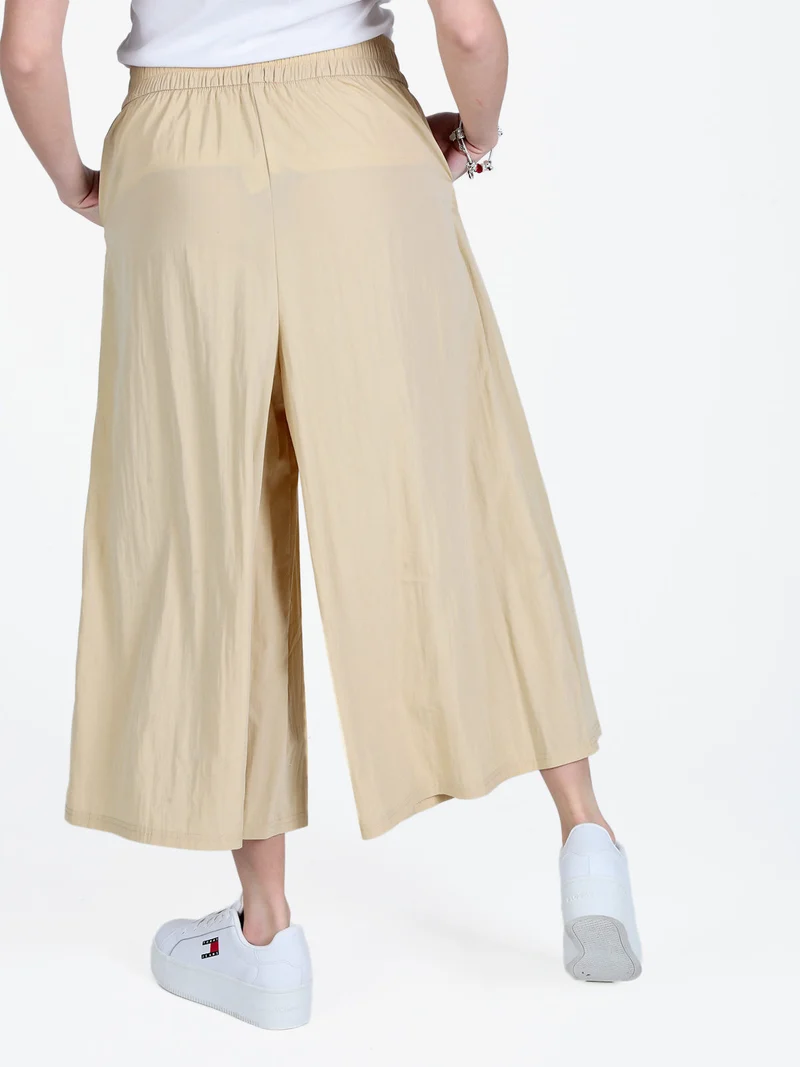 Pantaloni donna cropped a palazzo effetto crespo - beige
