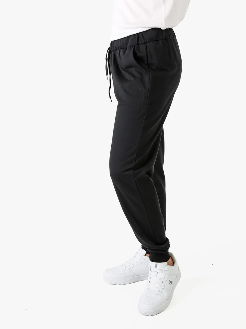 Pantaloni tuta da uomo in felpa con coulisse e polsini - nero