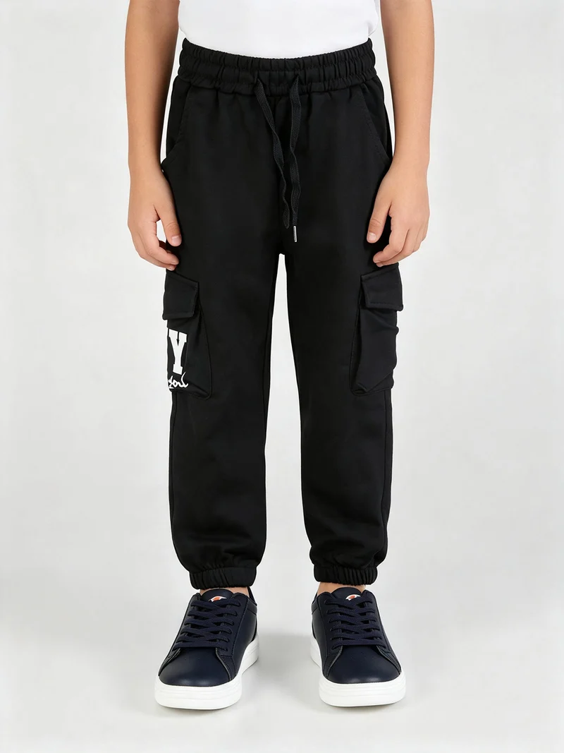 Pantaloni sportivi da bambino con tasconi laterali e interno felpato - nero