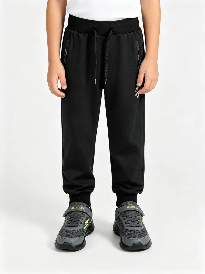 Pantaloni tuta da bambino con coulisse e polsini - nero