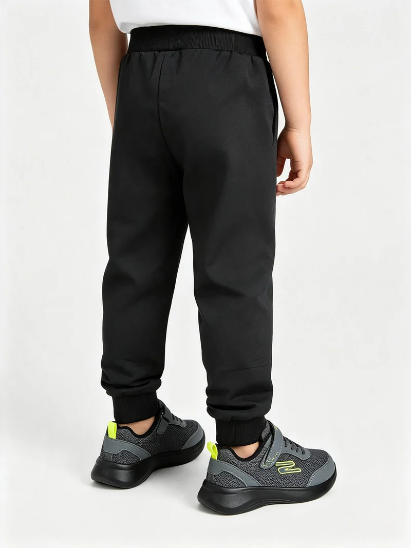 Pantaloni tuta da bambino con coulisse e polsini - nero