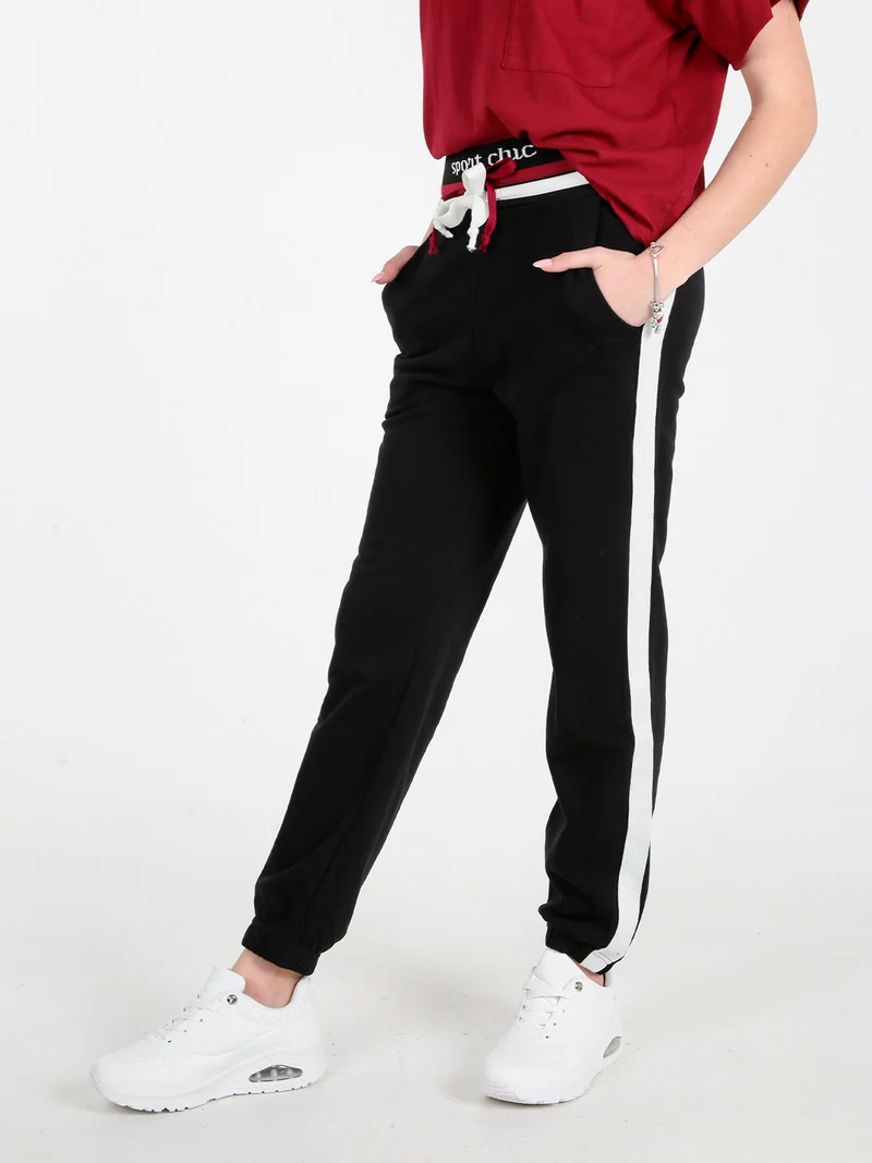 Pantaloni tuta da donna con coulisse e polsini - nero