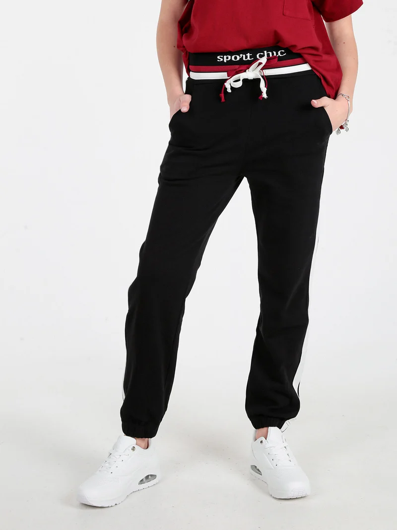 Pantaloni tuta da donna con coulisse e polsini - nero