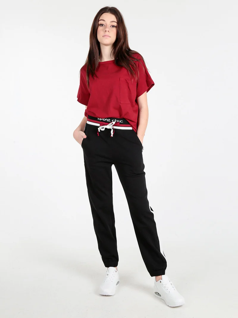 Pantaloni tuta da donna con coulisse e polsini - nero