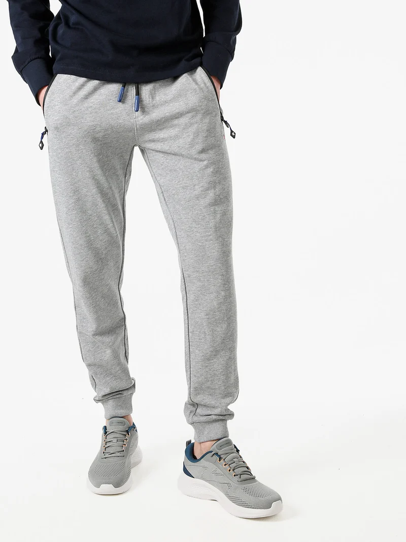 Pantaloni tuta da uomo con coulisse e polsini - grigio