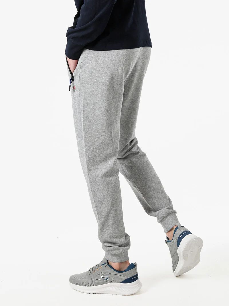 Pantaloni tuta da uomo con coulisse e polsini - grigio