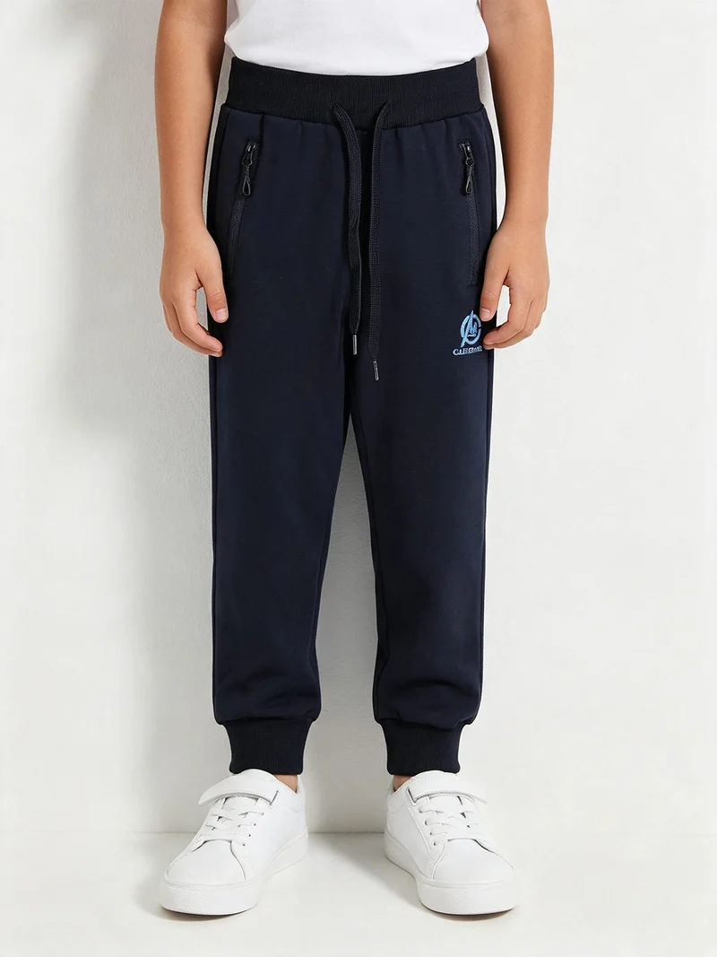 Pantaloni tuta da ragazzo con coulisse e polsini - blu scuro