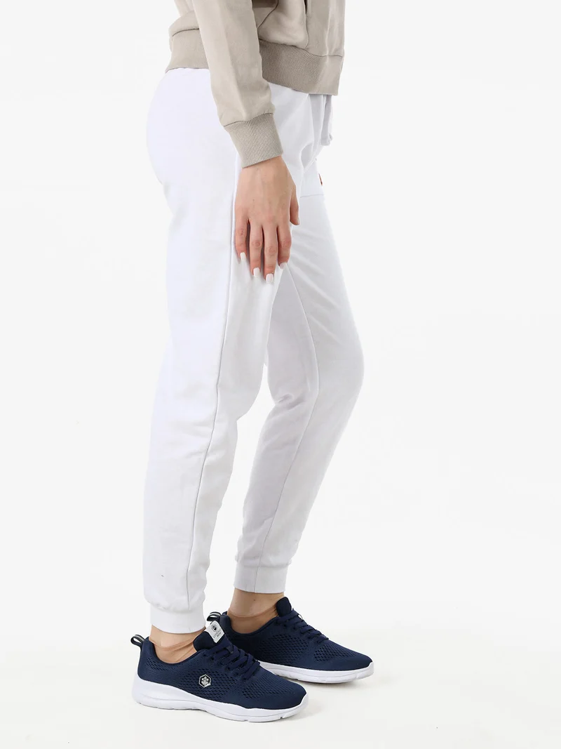 Pantaloni tuta da donna in cotone con coulisse e polsini - bianco