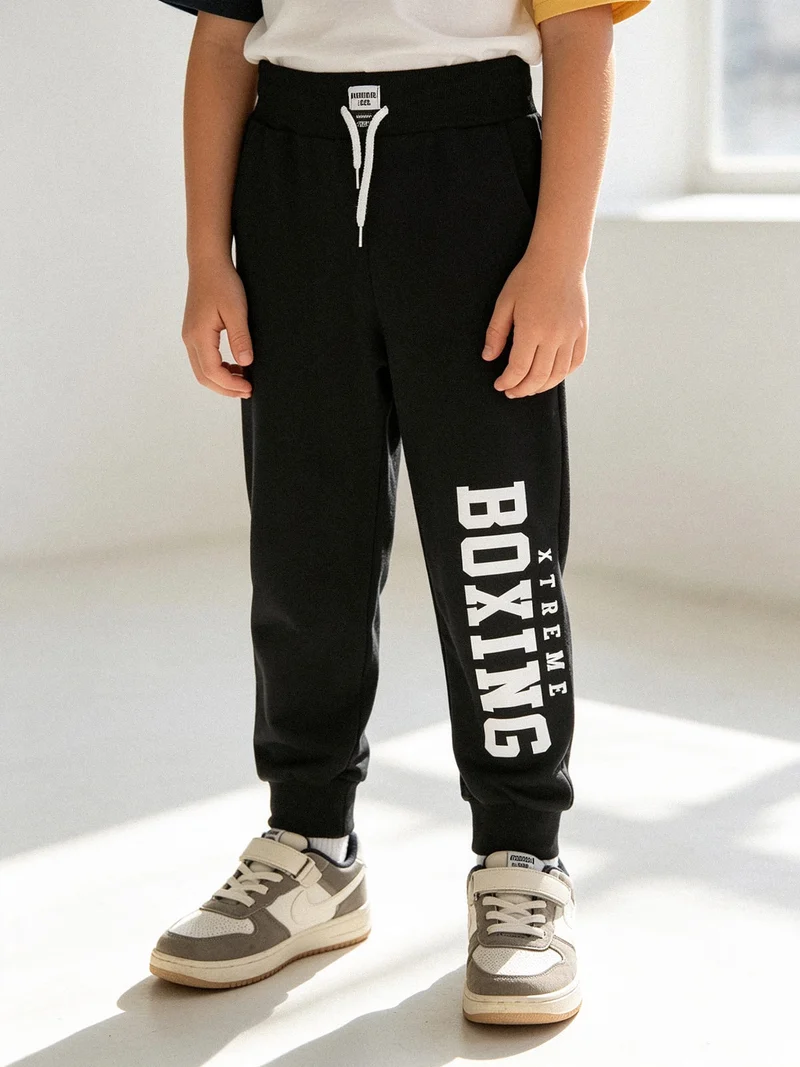Pantaloni sportivi da ragazzo con coulisse e polsini - nero
