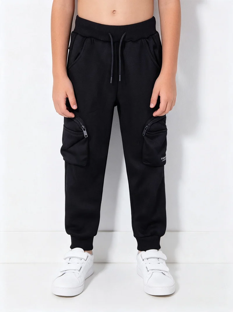 Pantaloni da bambino con tasconi laterali e polsini - blu scuro