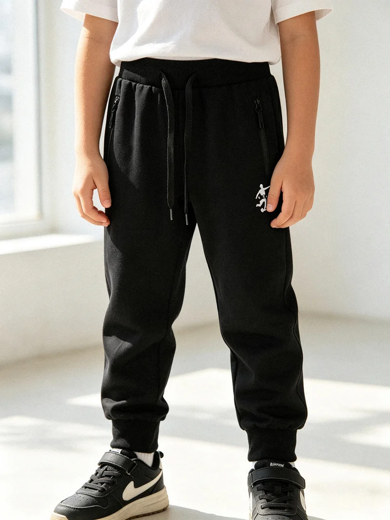 Pantaloni tuta da bambino con coulisse e polsini - nero