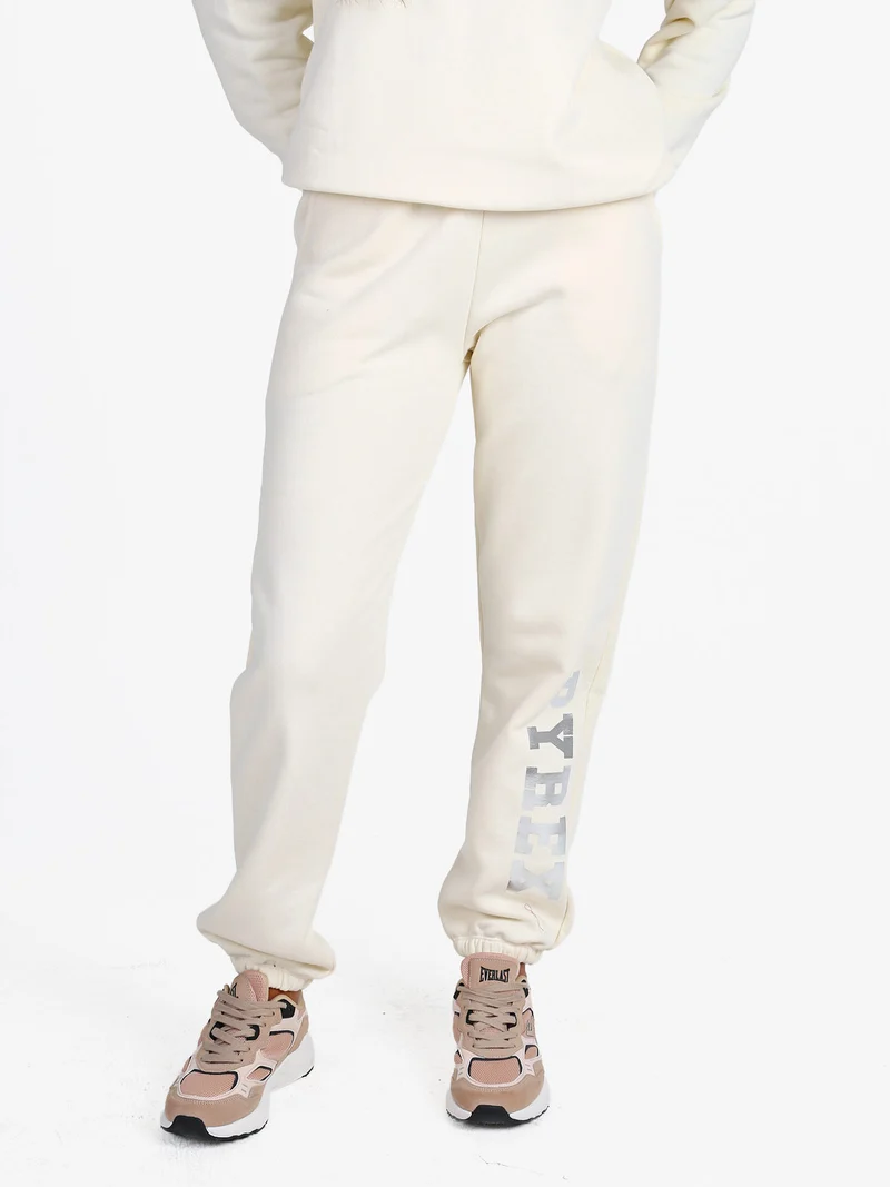 Pantaloni tuta da donna felpati con elastico finale - panna