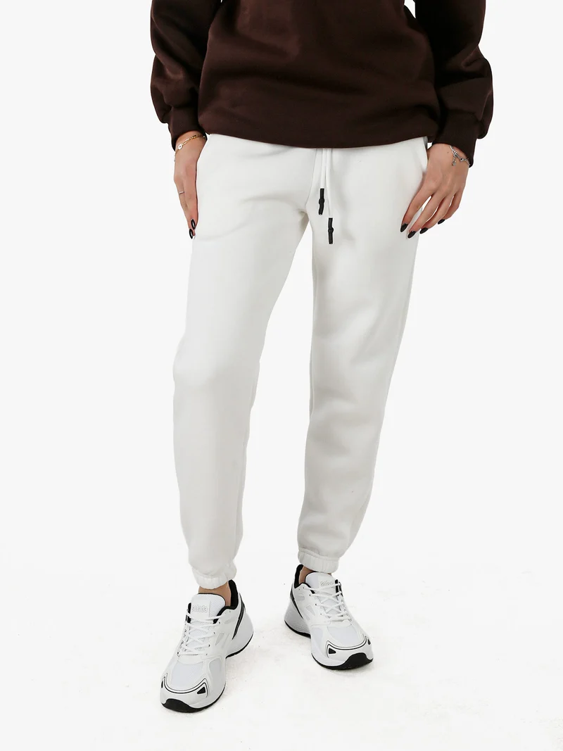 Pantaloni tuta da donna felpati con coulisse - bianco