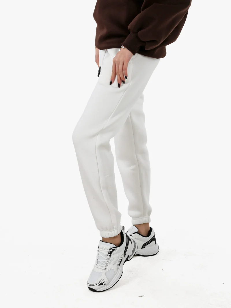 Pantaloni tuta da donna felpati con coulisse - bianco
