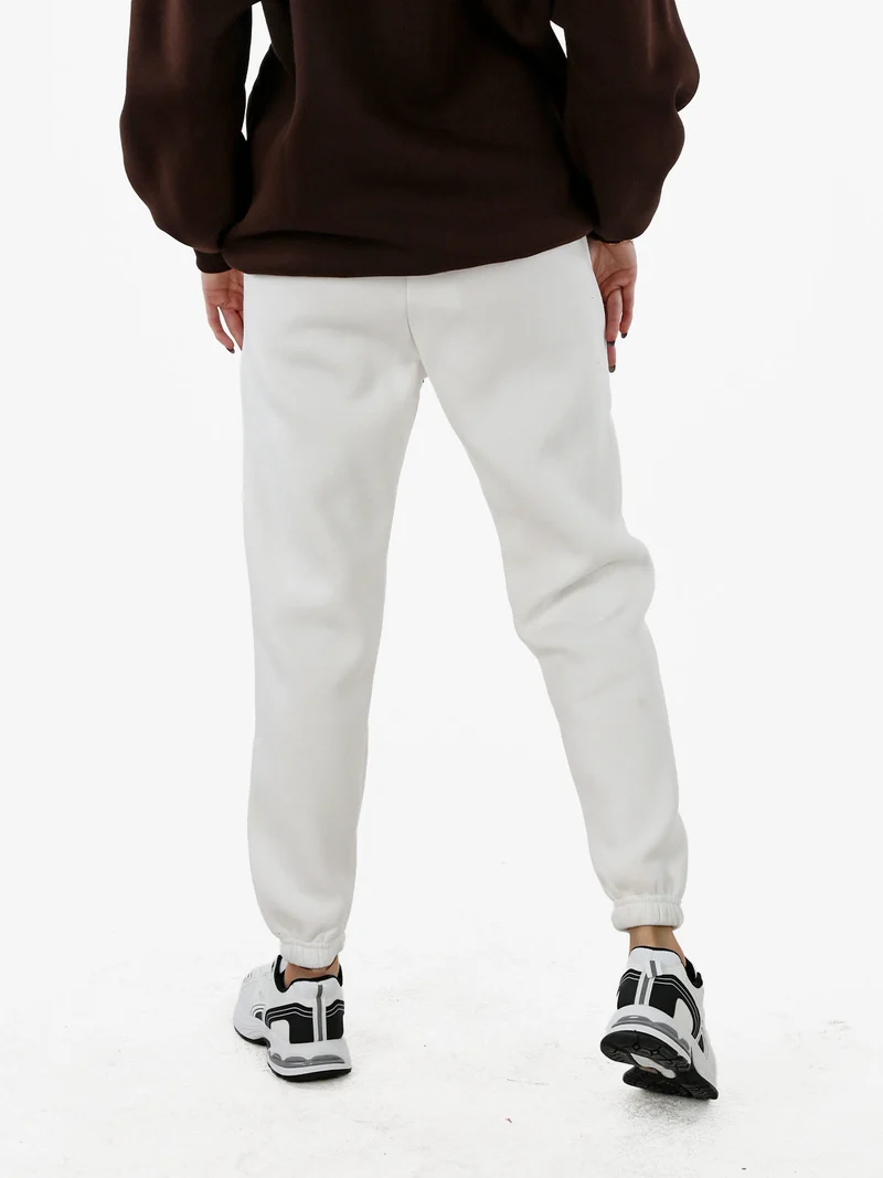 Pantaloni tuta da donna felpati con coulisse - bianco