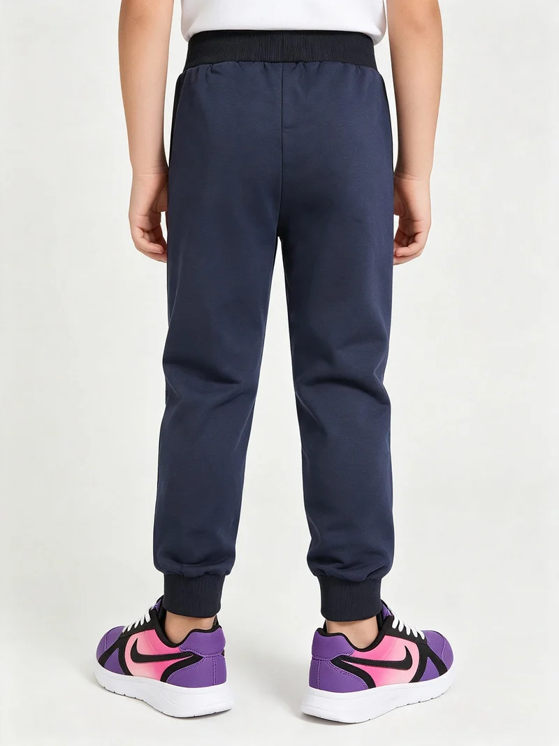 Pantaloni tuta da bambino con coulisse e polsini - blu scuro