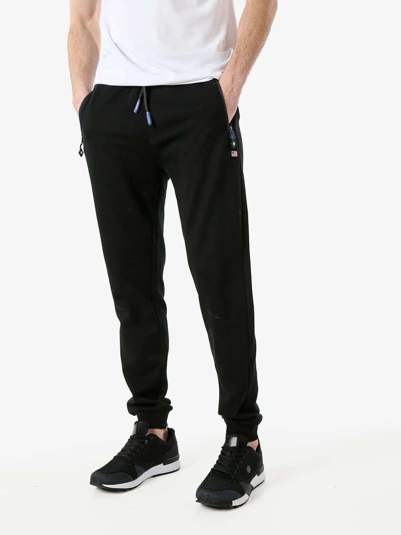 Pantaloni tuta da uomo con coulisse e polsini - nero