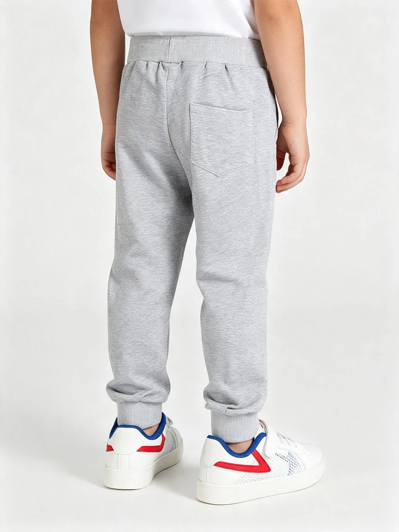 Pantaloni tuta da bambino con polsini e coulisse - grigio