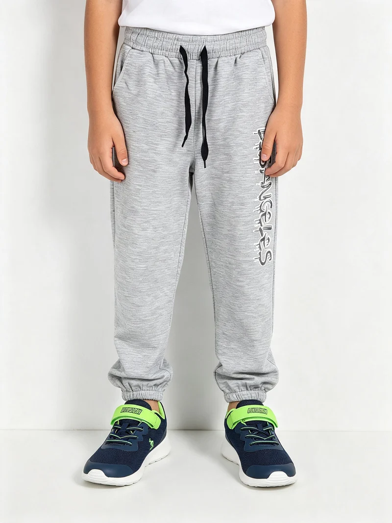 Pantaloni tuta da bambino con coulisse ed elastico sul finale - grigio