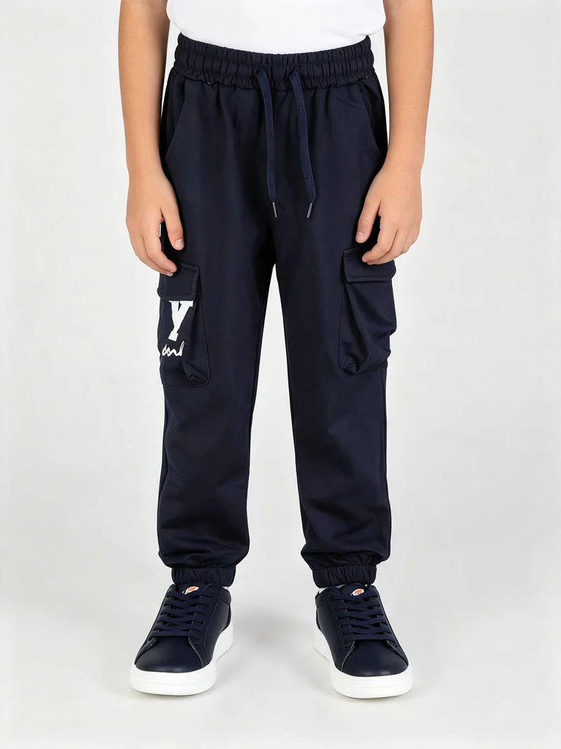 Pantaloni sportivi da bambino con tasconi laterali e interno felpato - blu scuro