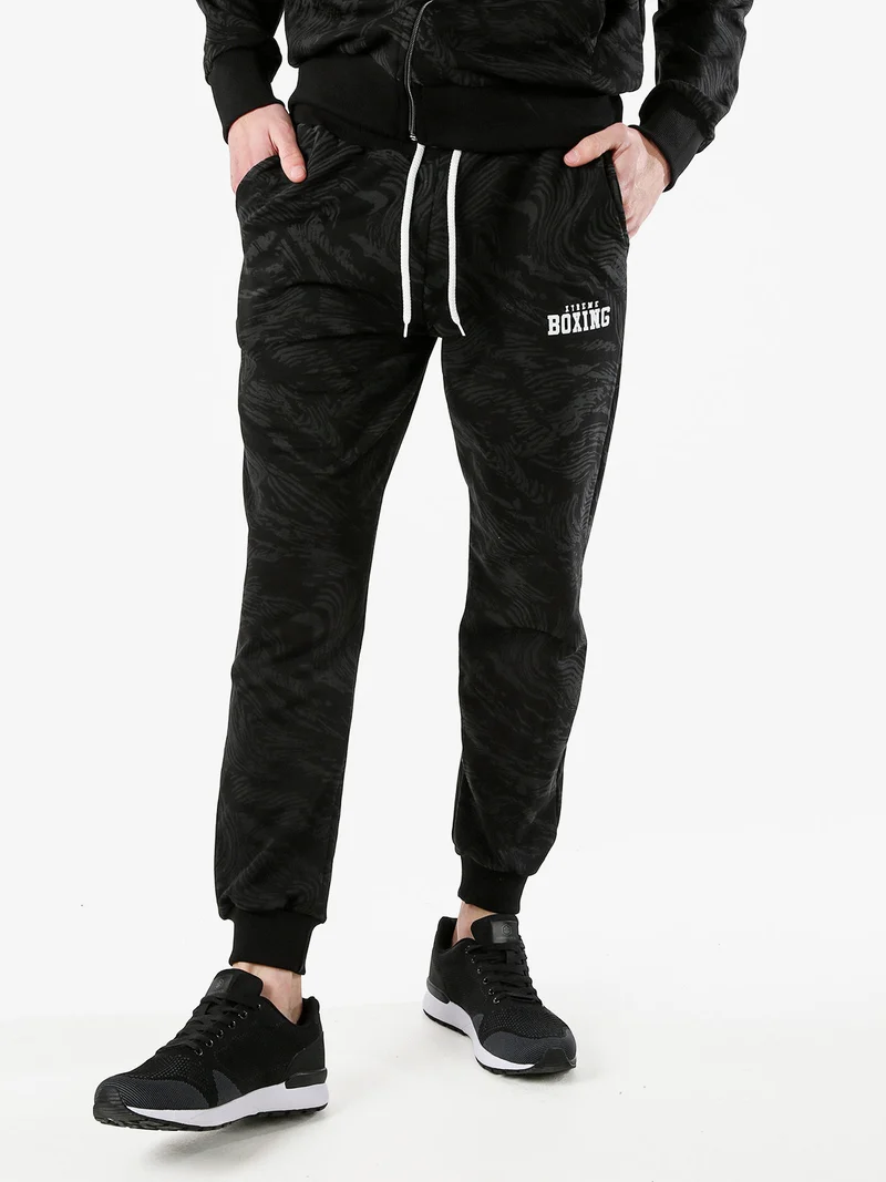 Pantaloni tuta da uomo in cotone con stampe e polsini - nero