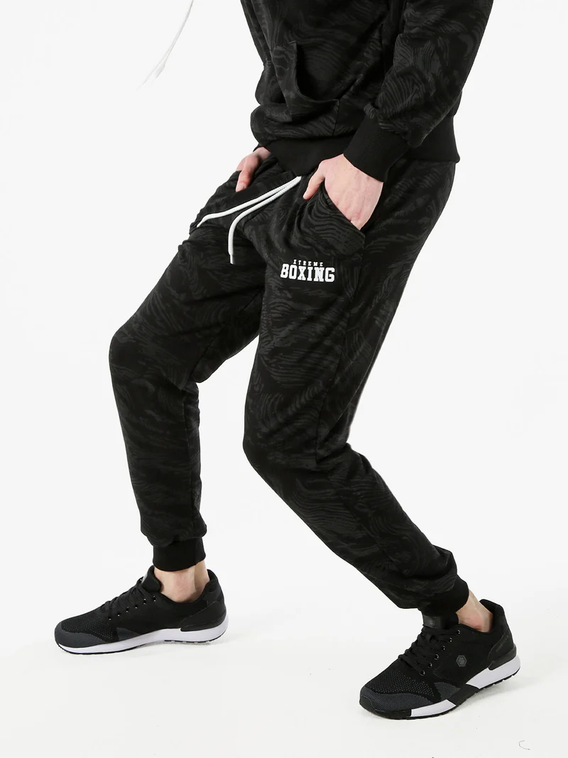 Pantaloni tuta da uomo in cotone con stampe e polsini - nero