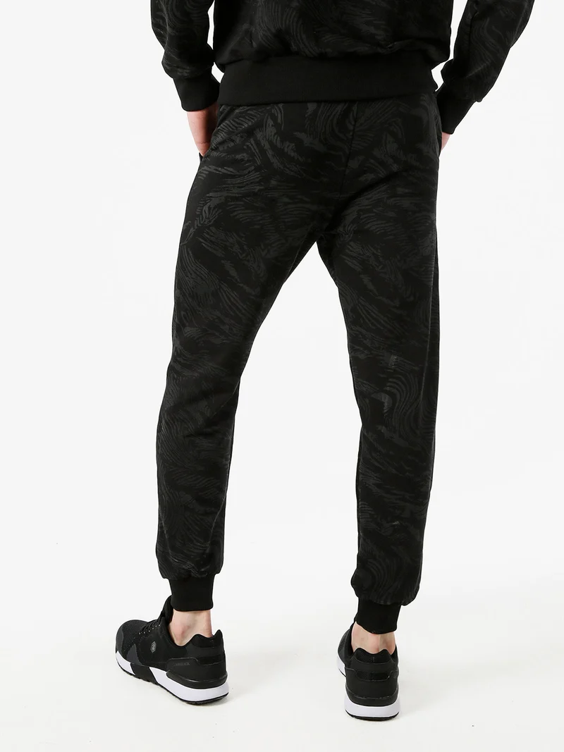 Pantaloni tuta da uomo in cotone con stampe e polsini - nero
