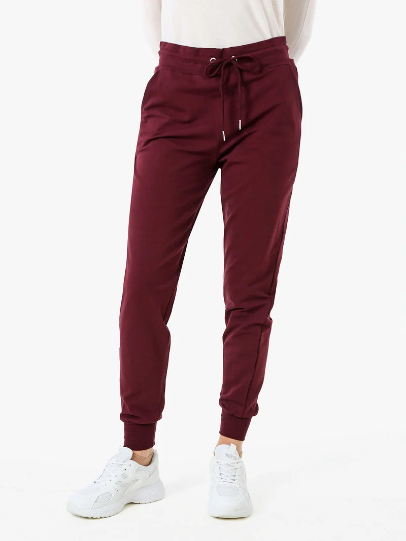 Pantaloni tuta da donna in cotone con coulisse e polsini - bordeaux