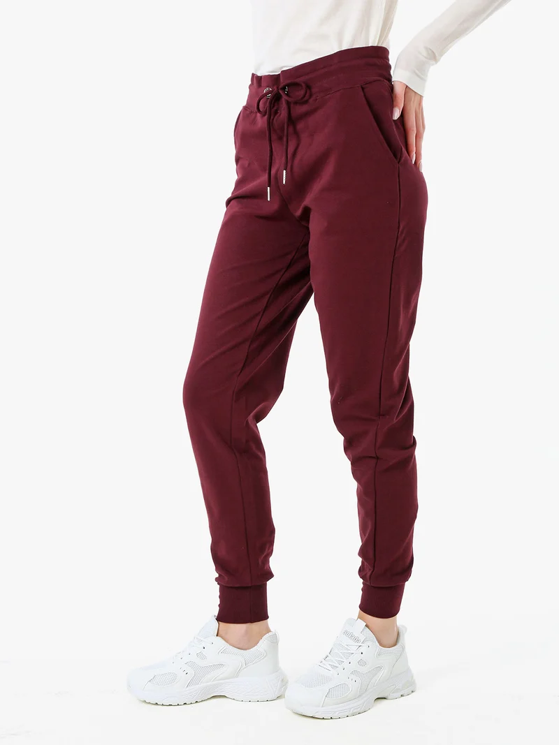 Pantaloni tuta da donna in cotone con coulisse e polsini - bordeaux