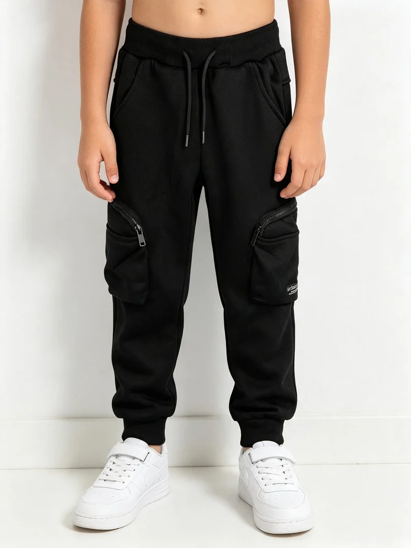 Pantaloni da bambino con tasconi laterali e polsini - nero