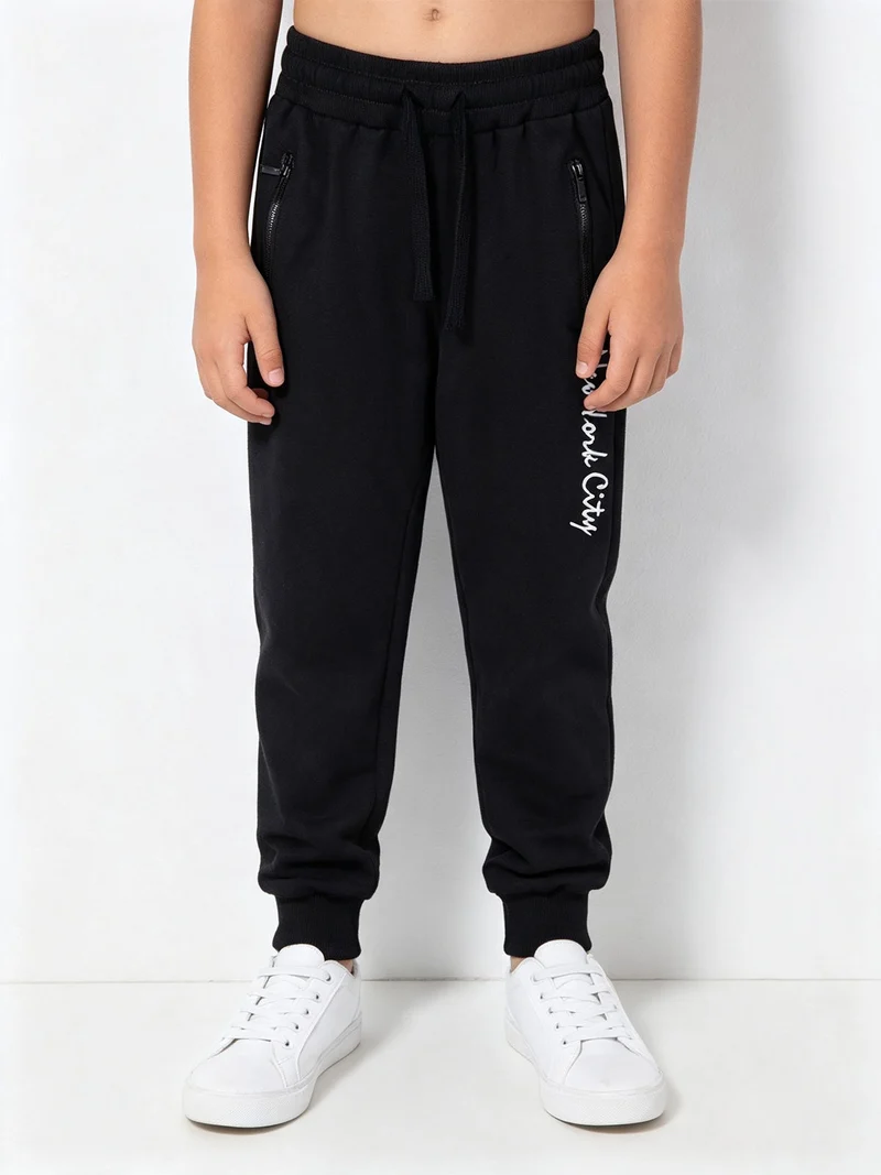 Pantaloni tuta da bambino con polsini - blu scuro